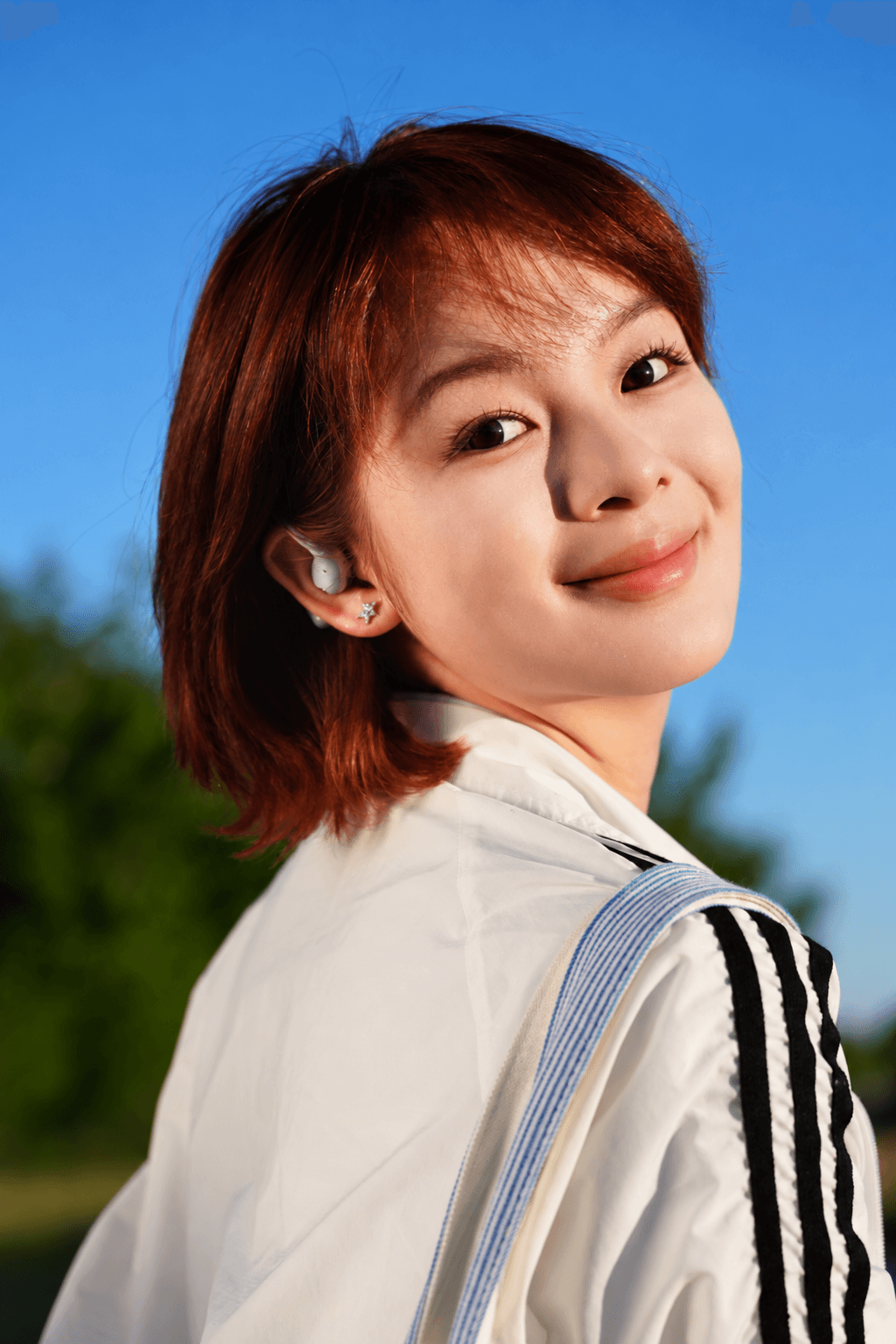 A1 open-ear earbud worn in a conversation setting